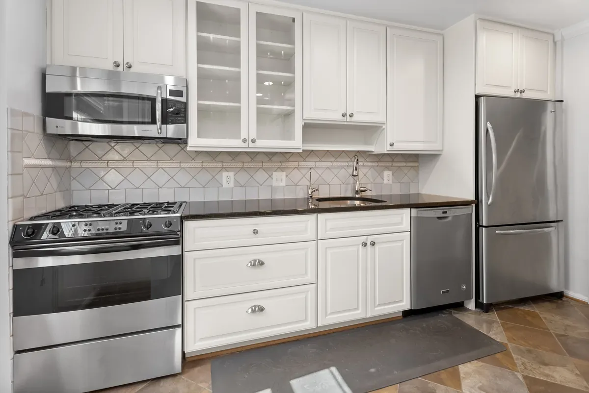 White kitchen with stainless appliances