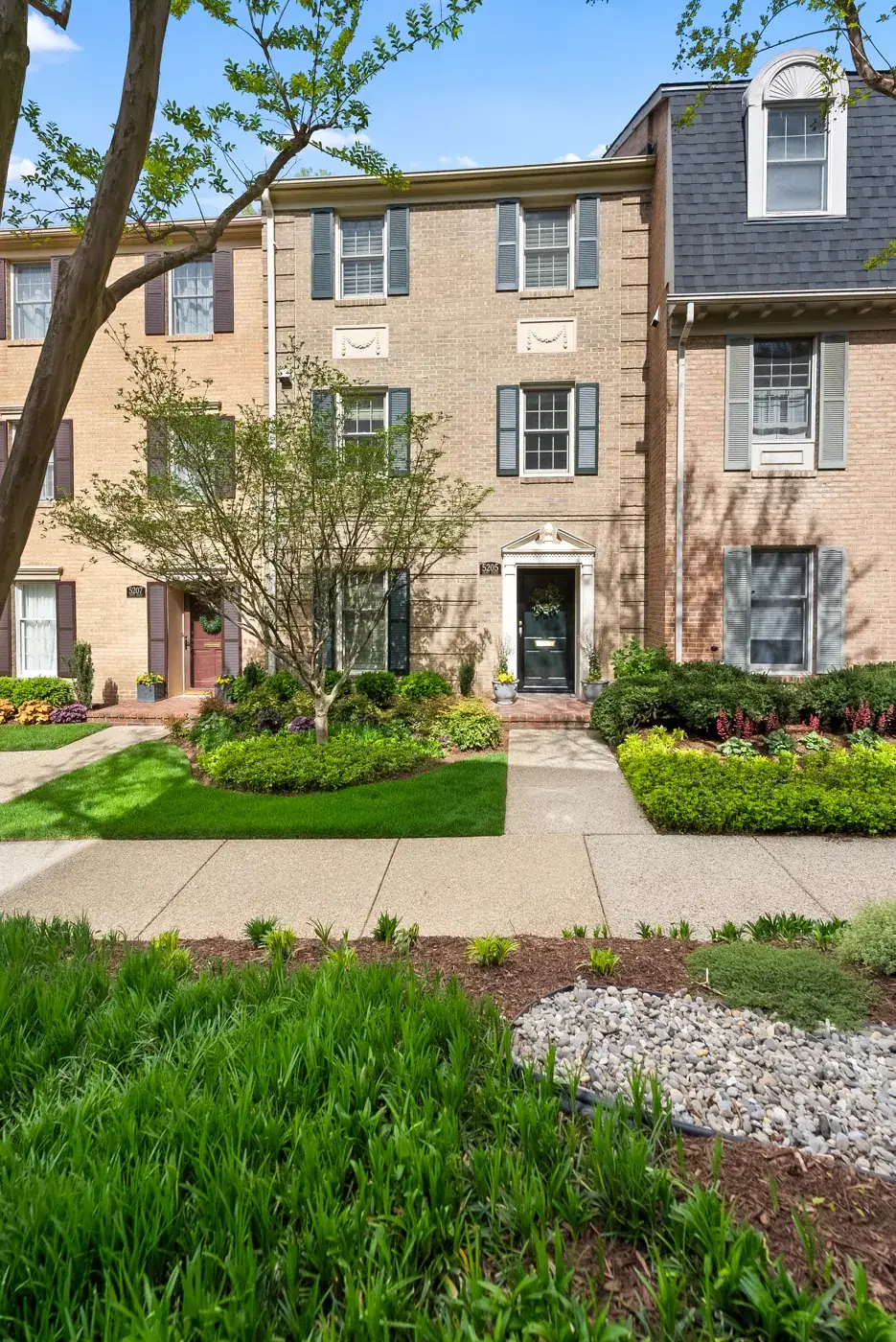 Brick townhome with landscaped walkway